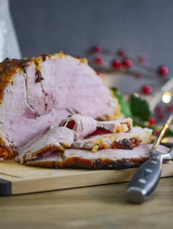 Sliced Christmas glazed ham on ProCook chopping board