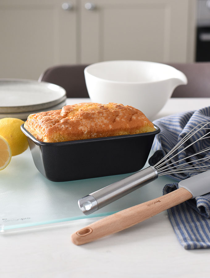 Everything for simple bakes surrounding a lemon drizzle cake baked in a ProCook loaf tin