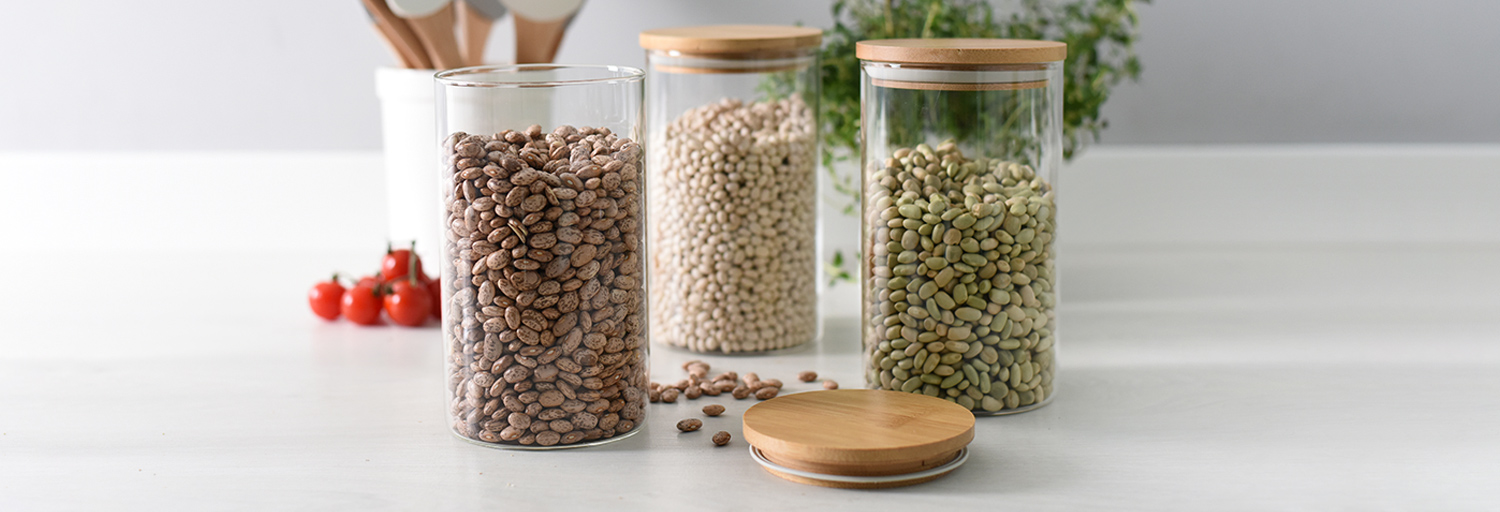 Set of 3 ProCook glass storage jars with wooden lids filled with dry ingredients