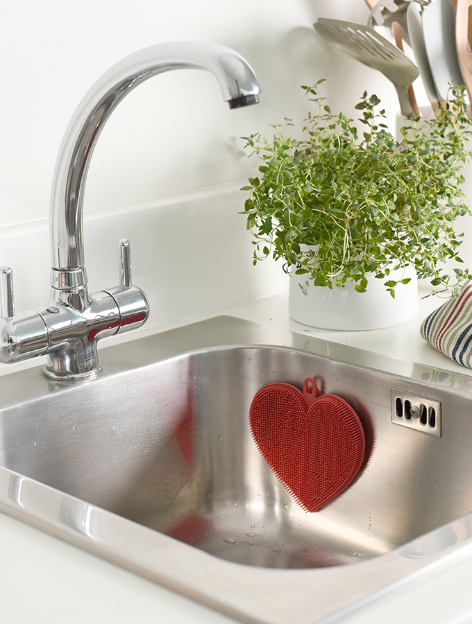 ProCook heart shaped Silicone Scrubber in sink for cleaning dishes