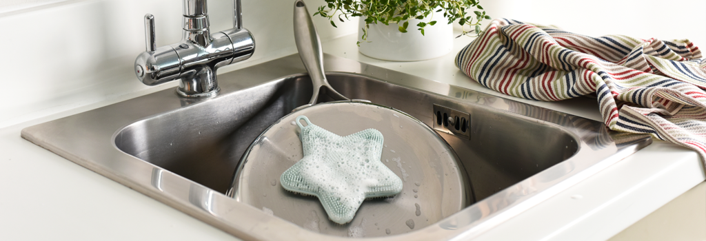 ProCook Silicone Scrubber cleaning a frying pan